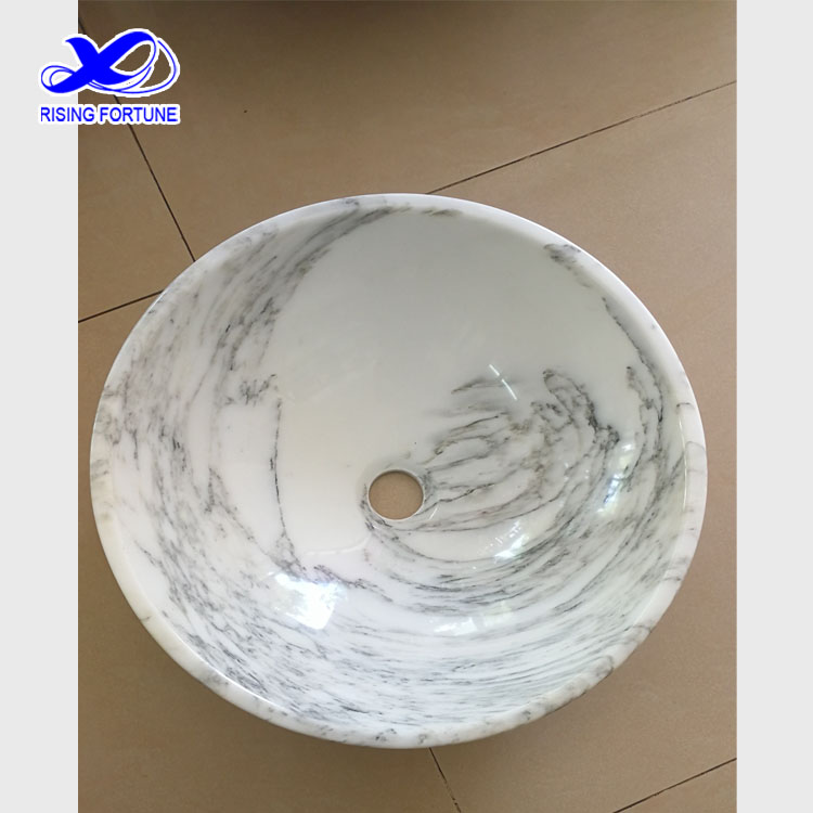 white marble round vessel sink
